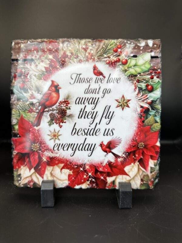 A square cut of stone with a glossy image of brilliant red cardinals surrounding the text, 'Those we love don't go away, they fly beside us everyday'