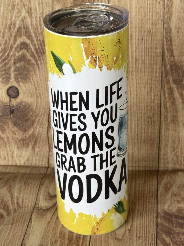 20 ounce tumbler with lemon background. Text reads "When life gives you lemons grab the Vodka"
