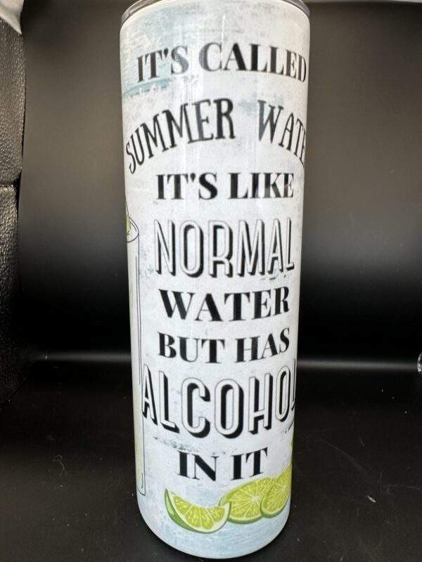A tumbler with the image of a few sliced limes on the bottom and the words, 'It's called summer water. It's like normal water but has alcohol in it.'