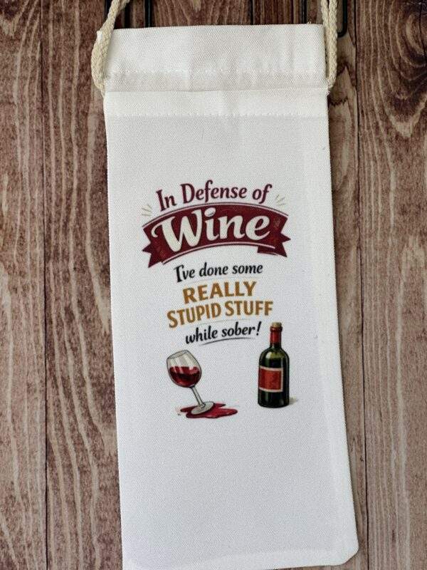 White cloth wine bag with glass and bottle. Text reads, 'In defense of wine, I've done some really stupid stuff while sober!'