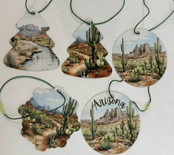 A collection of aluminum ornaments in different shapes featuring the Arizona desert.