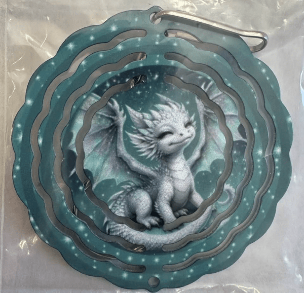 A smaller windspinner with a cheerful, smiling white dragon on a teal background.