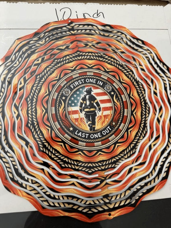 A windspinner showing a uniformed firefighter against an American flag, surrounded by a red, black, and gray abstract pattern.