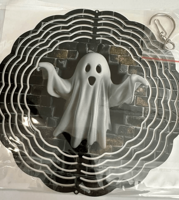 Windspinner on black with a spooky sheet-style ghost coming through a hole in a brick wall.