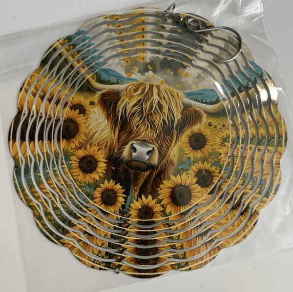 A peaceful field of sunflowers and a shaggy highland cow chilling in the center.